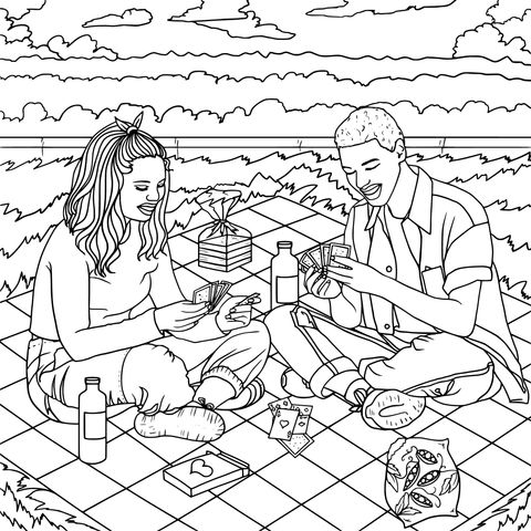 Pareja having un picnic y jugando a cartas