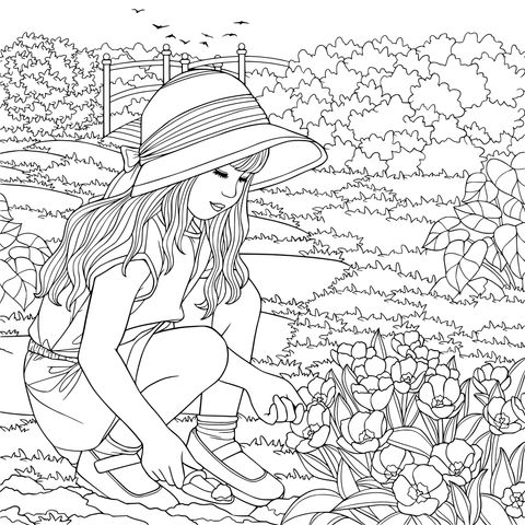 Girl planting flowers in the garden