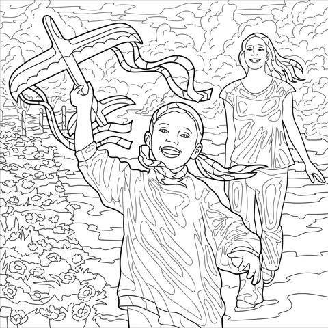 Mother and daughter flying a kite by the flower - bed