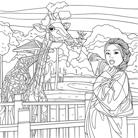 女士在动物园喂长颈鹿